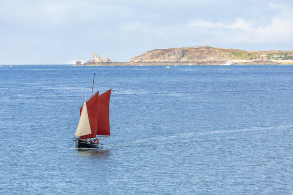 Sailing boat with Grand Bé isle on the background. Saint-Malo, Ille-et-Vilaine, Brittany, France.