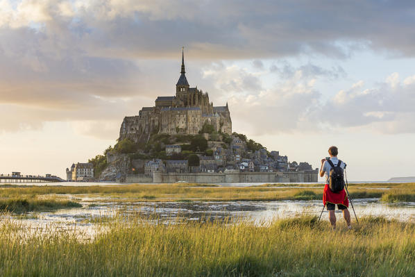 Man taking pictures at sunset. Mont-Saint-Michel, Normandy, France.