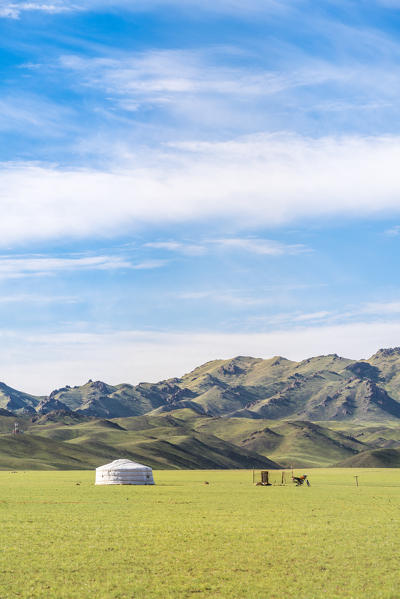 Nomadic ger, motorbike and mountains in the background. Bayandalai district, South Gobi province, Mongolia.