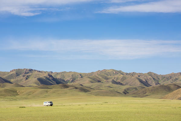 Soviet minivan and mountains in the background. Bayandalai district, South Gobi province, Mongolia.