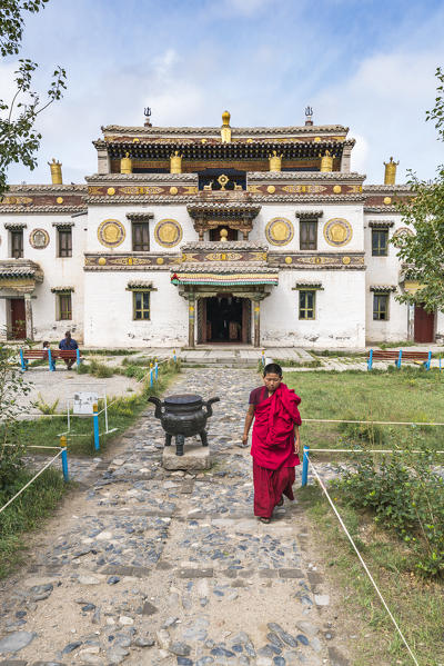 Buddhist monk walking in the gardens of Erdene Zuu Buddhist monastery. Harhorin, South Hangay province, Mongolia.