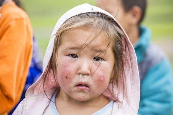 Portrait of a Mongolian Nomadic little girl with hood. North Hangay province, Mongolia.
