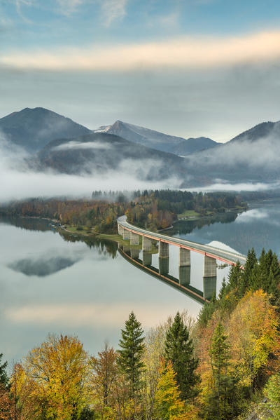 Sylvenstein Lake and bridge surrounded by the morning mist. Bad Tölz-Wolfratshausen district, Bavaria, Germany.
