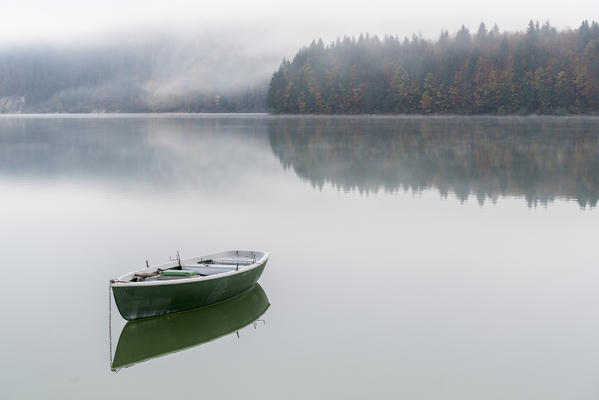 Boat on Sylvenstein Lake in the morning. Bad Tölz-Wolfratshausen district, Bavaria, Germany.