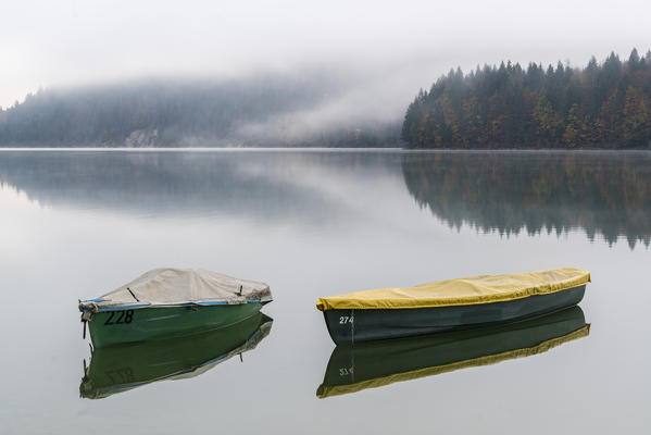 Boats on Sylvenstein Lake in the morning. Bad Tölz-Wolfratshausen district, Bavaria, Germany.