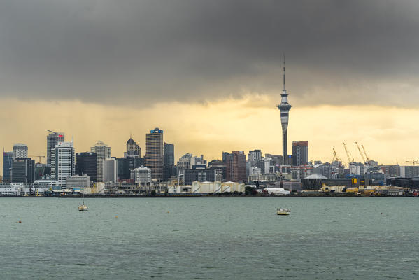 Skyline of Auckland CBD under a gloomy sky at sunrise. Auckland City, Auckland region, North Island, New Zealand.