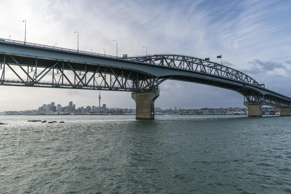 Auckland Harbour Bridge with Auckland skyline in the background. Auckland City, Auckland region, North Island, New Zealand.