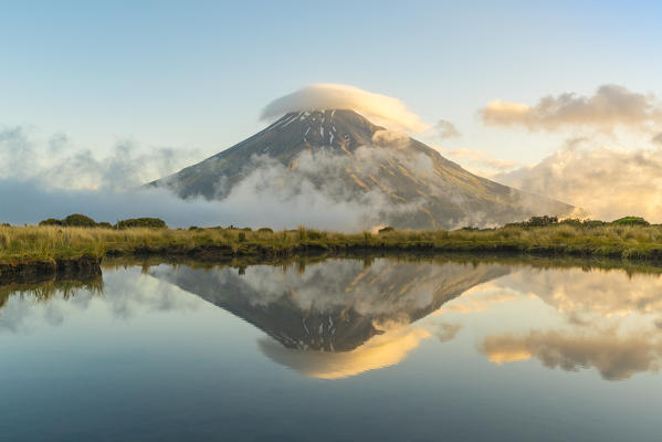 Reflection of Mount Taranaki before sunset. Egmont National Park, New Plymouth district, Taranaki region, North Island, New Zealand.