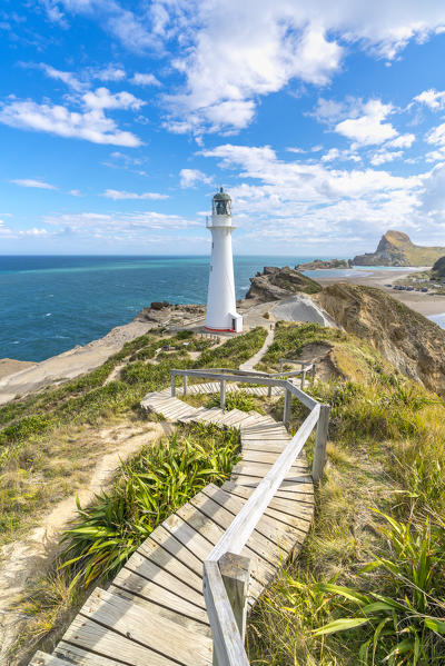 Castlepoint lighthouse and Castle Rock in the background. Castlepoint, Wairarapa region, North Island, New Zealand.