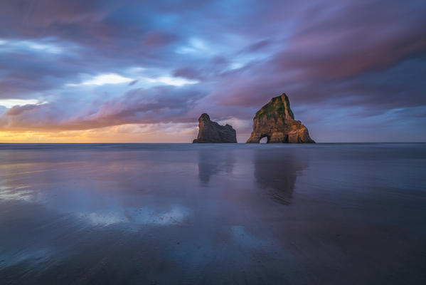 Sunset clouds above Archway Islands. Wharariki beach, Puponga, Tasman district, South Island, New Zealand.