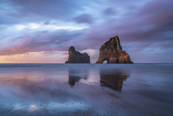 Sunset clouds above Archway Islands. Wharariki beach, Puponga, Tasman district, South Island, New Zealand.