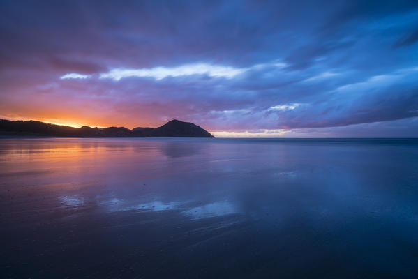 Sunset from Wharariki beach. Puponga, Tasman district, South Island, New Zealand.