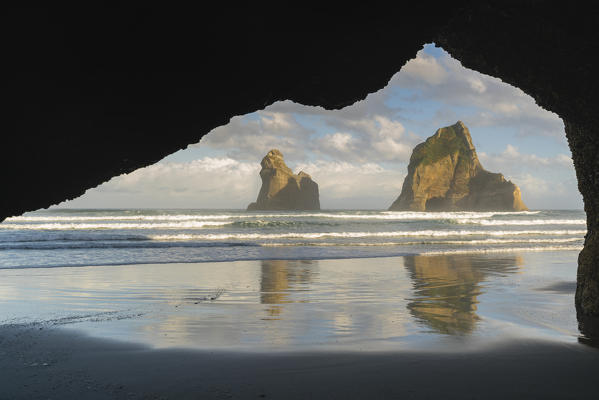 Archway Islands seen from a rock cave. Wharariki beach, Puponga, Tasman district, South Island, New Zealand.
