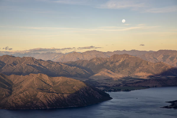 Moonlight over Lake Wanaka and Mt Aspiring NP at sunset. Wanaka, Queenstown Lakes district, Otago region, South Island, New Zealand.