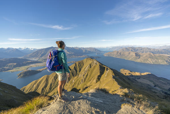 Woman admiring Lake Wanaka from Roys Peak track. Wanaka, Queenstown Lakes district, Otago region, South Island, New Zealand. (MR)
