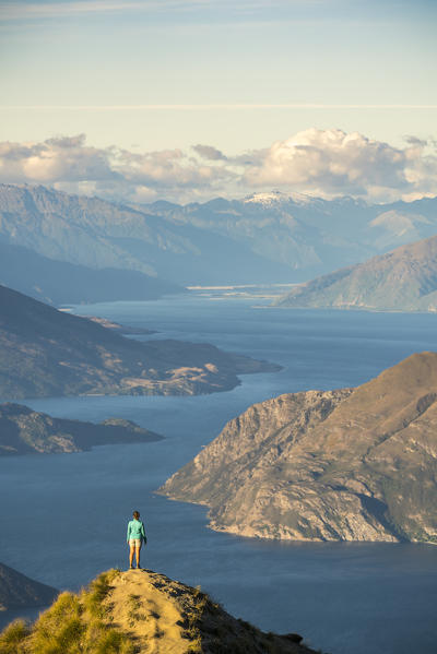 Woman admiring the view from Roys Peak lookout. Wanaka, Queenstown Lakes district, Otago region, South Island, New Zealand.