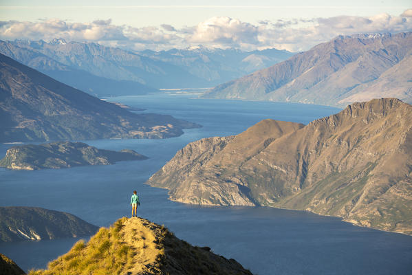 Woman admiring the view from Roys Peak lookout. Wanaka, Queenstown Lakes district, Otago region, South Island, New Zealand. (MR)