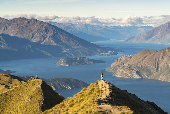 Woman admiring the view from Roys Peak lookout. Wanaka, Queenstown Lakes district, Otago region, South Island, New Zealand. (MR)