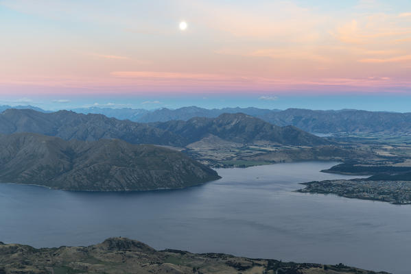 Moonlight over Lake Wanaka at sunset. Wanaka, Queenstown Lakes district, Otago region, South Island, New Zealand.