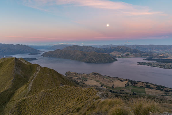 Moonlight over Lake Wanaka at sunset. Wanaka, Queenstown Lakes district, Otago region, South Island, New Zealand.