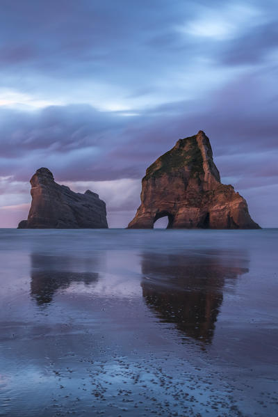 Sunset clouds above Archway Islands. Wharariki beach, Puponga, Tasman district, South Island, New Zealand.