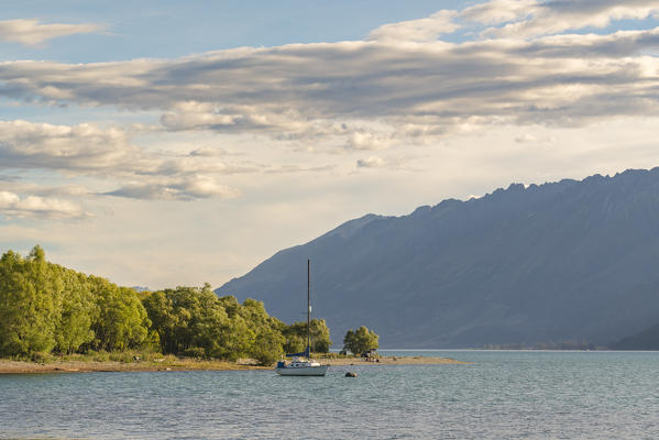 Boat on Lake Wakatipu and mountains in the background. Glenorchy, Queenstown Lakes district, Otago region, South Island, New Zealand.