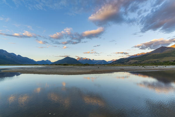 Clouds in the sky above Lake Wakatipu and mountains at sunset. Glenorchy, Queenstown Lakes district, Otago region, South Island, New Zealand.
