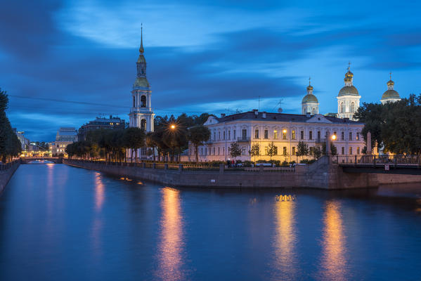 The bell tower and domes of Saint Nicholas Naval Cathedral on Griboyedov Canal at dusk. Saint Petersburg, Russia.