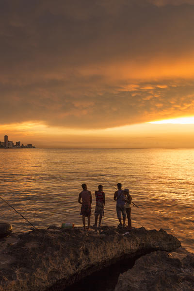 Young boys fishing at the Malecon in Old Havana, Havana, Havana Province, Cuba