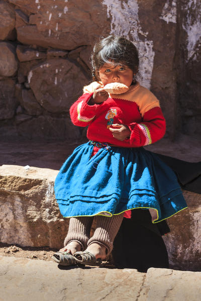 People wearing traditional costumes on Isla Taquile on the Peruvian side of Lake Titicaca, Peru, South America