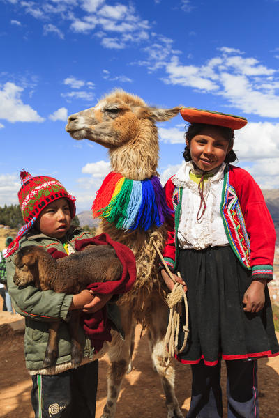 Children and llama in  Cuzco, Peru., South America