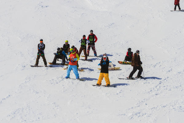 Snowboarders in the Mottolino snowpark in Livigno, Lombardy, Italy, Europe