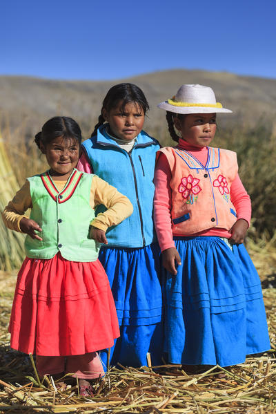 Children leaving on the Uros floating islands on Lake Titicaca, Puno, Peru