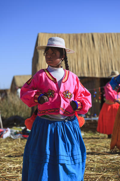Child leaving on the Uros floating islands on Lake Titicaca, Puno, Peru