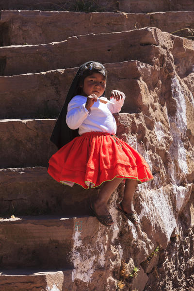 Child dressed for a ceremony on Isla Taquile on the Peruvian side of Lake Titicaca, Puno province, Peru
