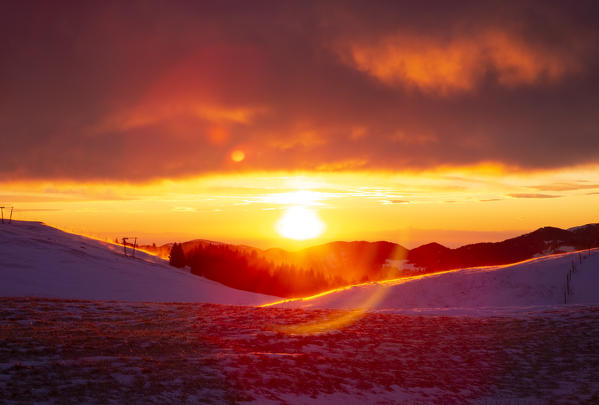 View of the Magnolini refuge during a winter sunset from Monte Pora, Val Seriana, Bergamo district, Lombardy, Italy.