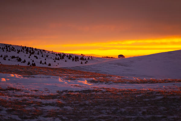 View of the Magnolini refuge during a winter sunset from Monte Pora, Val Seriana, Bergamo district, Lombardy, Italy.