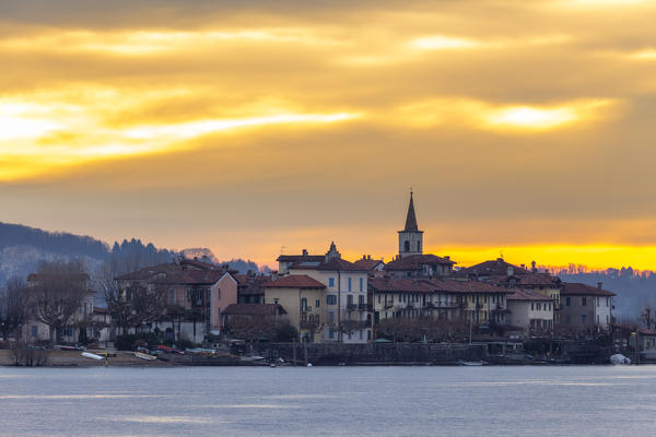 View of Isola dei Pescatori from the shore of Baveno in a winter sunrise, Piedmont, Italy.