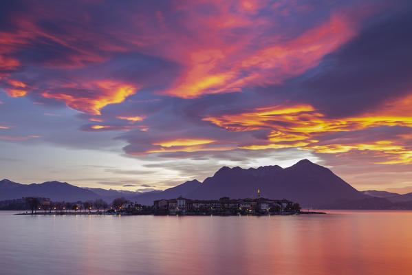 View of Isola dei Pescatori from the shore of Baveno in a winter sunrise, Piedmont, Italy.