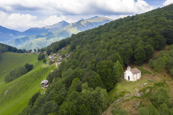 Aerial view of the pastures of Alpone di Curiglia and the church of Madonna della Guardia. Curiglia con Monteviasco, Veddasca valley, Varese district, Lombardy, Italy.
