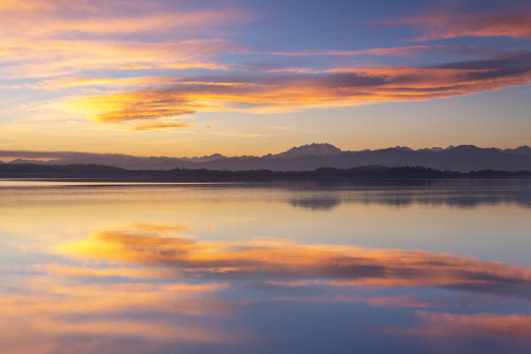 Monte Rosa reflecting on Lake Varese during a winter sunset at Calcinate del Pesce, Varese Province, Lombardy, Italy.