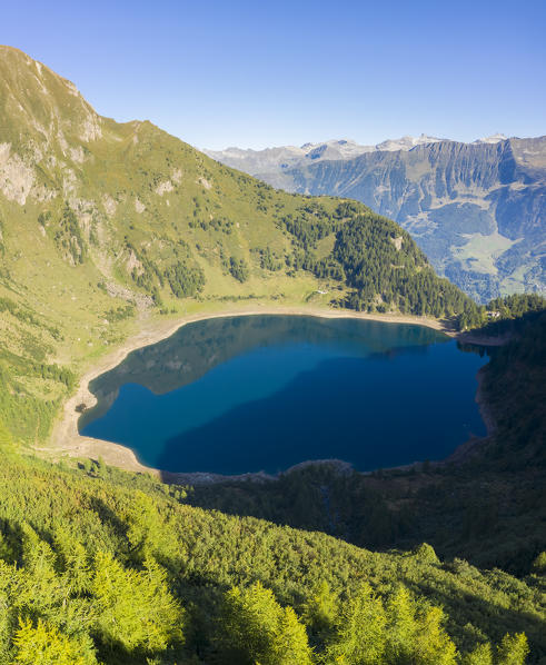 Aerial view at sunrise of the valley of Lago Tremorgio, from Alpe Campolungo with Valle Leventina and Pizzo del Sole below. Rodi, Prato Leventina, Valle Leventina, Canton Ticino, Switzerland.