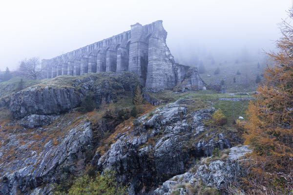 Autumnal view of the ruins of the Gleno dam. Pianezza, Vilminore di Scalve, Scalve Valley, Lombardy, Bergamo province, Italy.