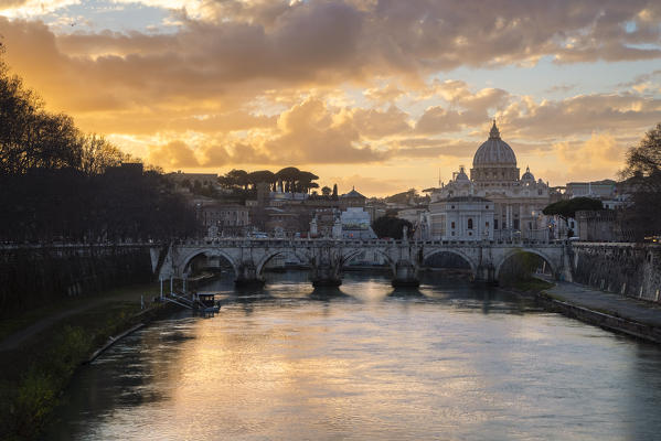 Sunset in Rome in front of the Basilica di San Pietro, Sant'Angelo bridge and the river Tevere from Umberto I bridge. Rome, Rome district, Lazio, Europe, Italy.