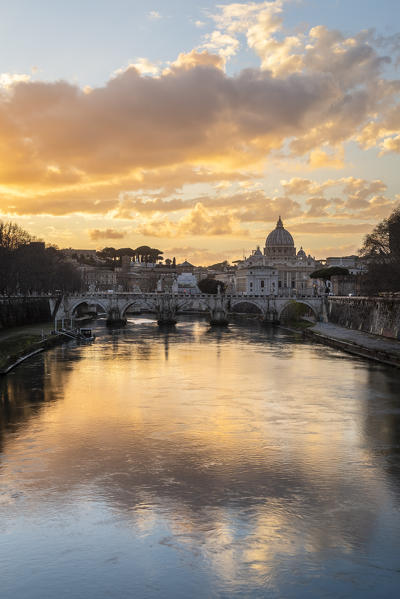 Sunset in Rome in front of the Basilica di San Pietro, Sant'Angelo bridge and the river Tevere from Umberto I bridge. Rome, Rome district, Lazio, Europe, Italy.