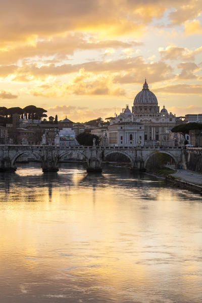 Sunset in Rome in front of the Basilica di San Pietro, Sant'Angelo bridge and the river Tevere from Umberto I bridge. Rome, Rome district, Lazio, Europe, Italy.