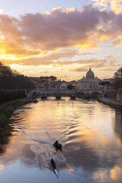 Sunset in Rome in front of the Basilica di San Pietro, Sant'Angelo bridge and the river Tevere from Umberto I bridge. Rome, Rome district, Lazio, Europe, Italy.