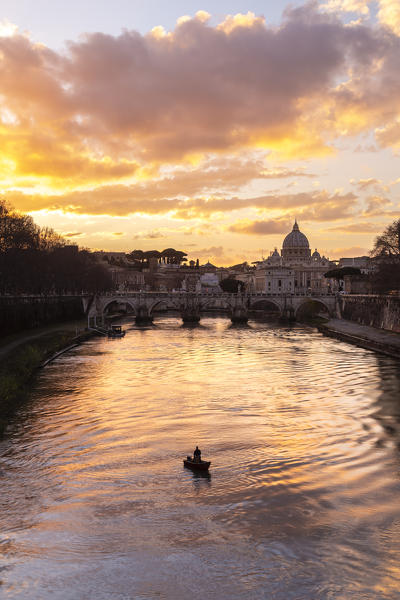 Sunset in Rome in front of the Basilica di San Pietro, Sant'Angelo bridge and the river Tevere from Umberto I bridge. Rome, Rome district, Lazio, Europe, Italy.