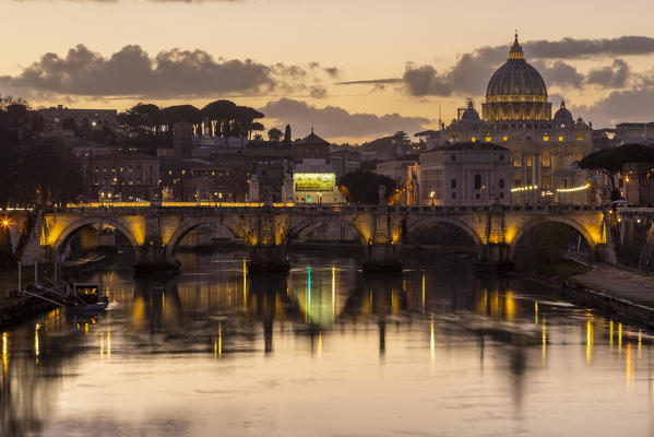 Sunset in Rome in front of the Basilica di San Pietro, Sant'Angelo bridge and the river Tevere from Umberto I bridge. Rome, Rome district, Lazio, Europe, Italy.
