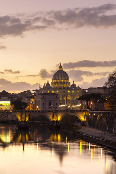 Sunset in Rome in front of the Basilica di San Pietro, Sant'Angelo bridge and the river Tevere from Umberto I bridge. Rome, Rome district, Lazio, Europe, Italy.